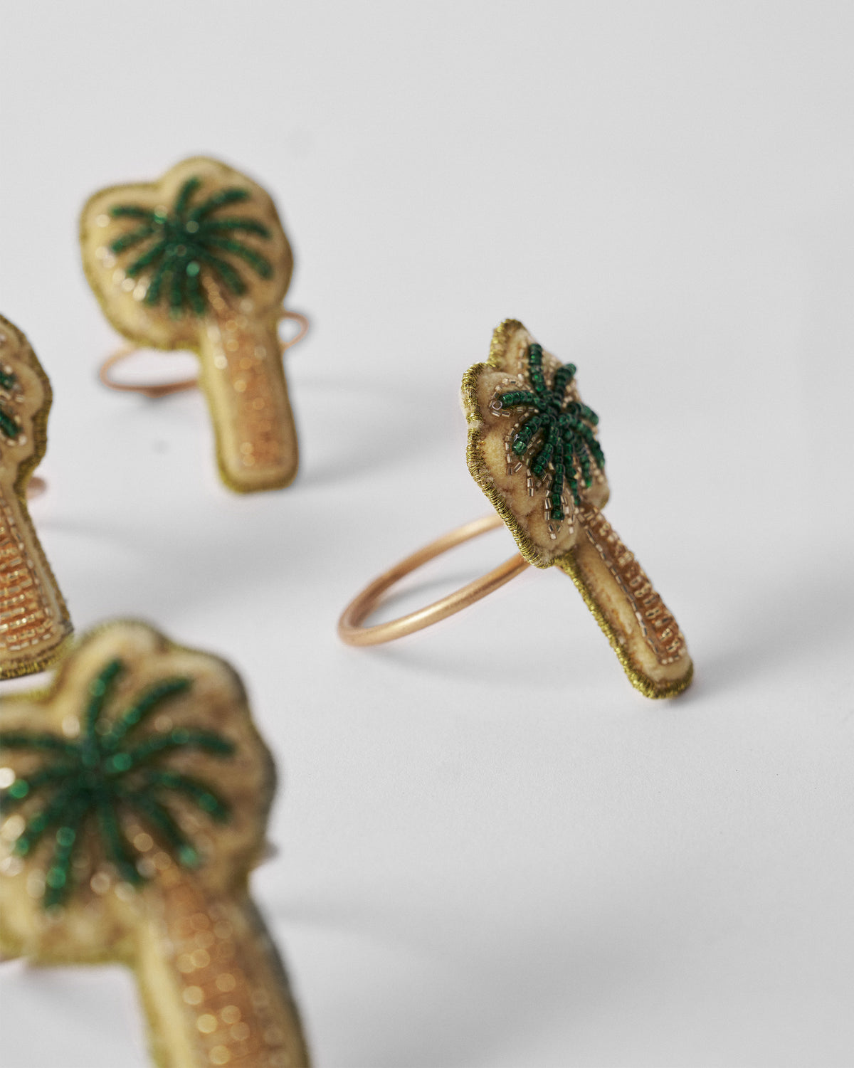 Side view of Palm napkin ring with gold-edged beaded palm.