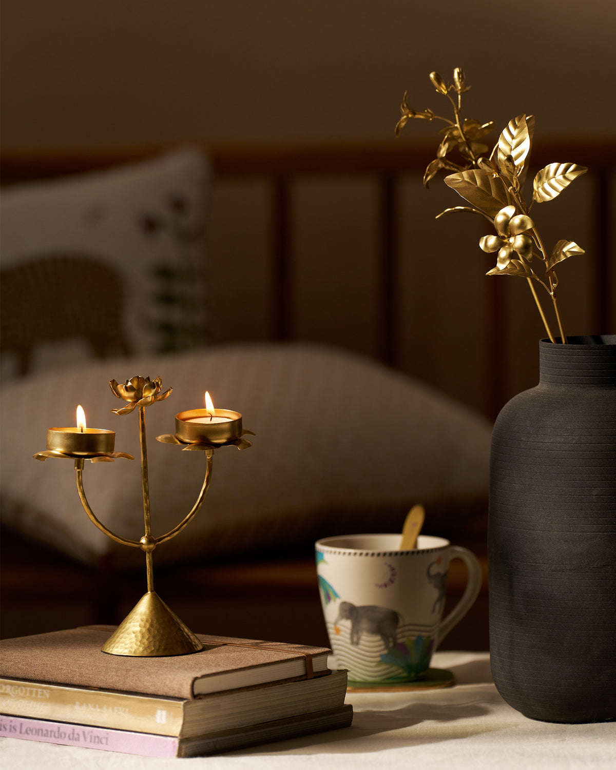 Lit Mogra bud tealight on stacked books.