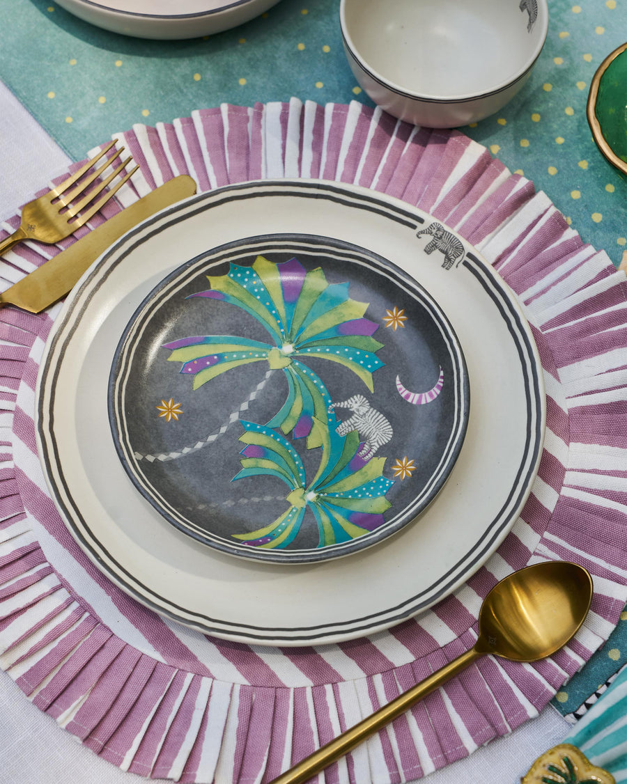 The Palm Bloom plate on a white plate over a pink fringed placemat