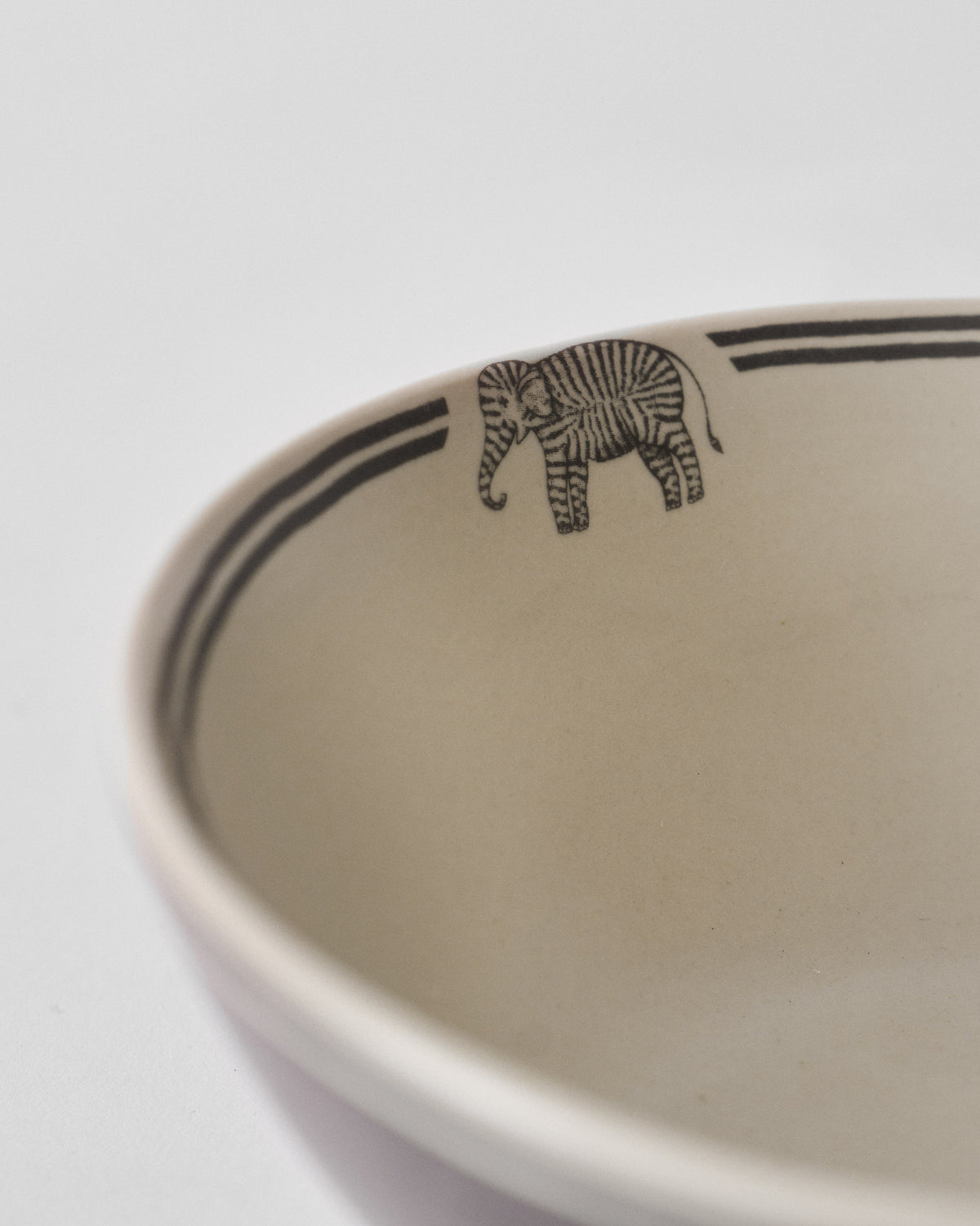 Close-up of the Palm Bloom Bowl rim showing a striped elephant motif.