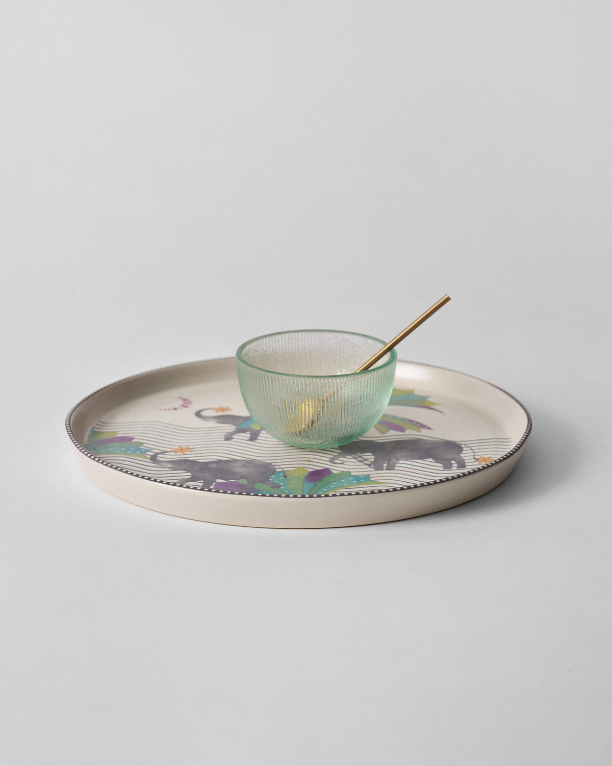 Tusk chip and dip platter with a green glass bowl and gold spoon.