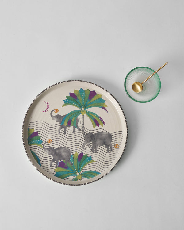 The platter with a small green bowl beside it