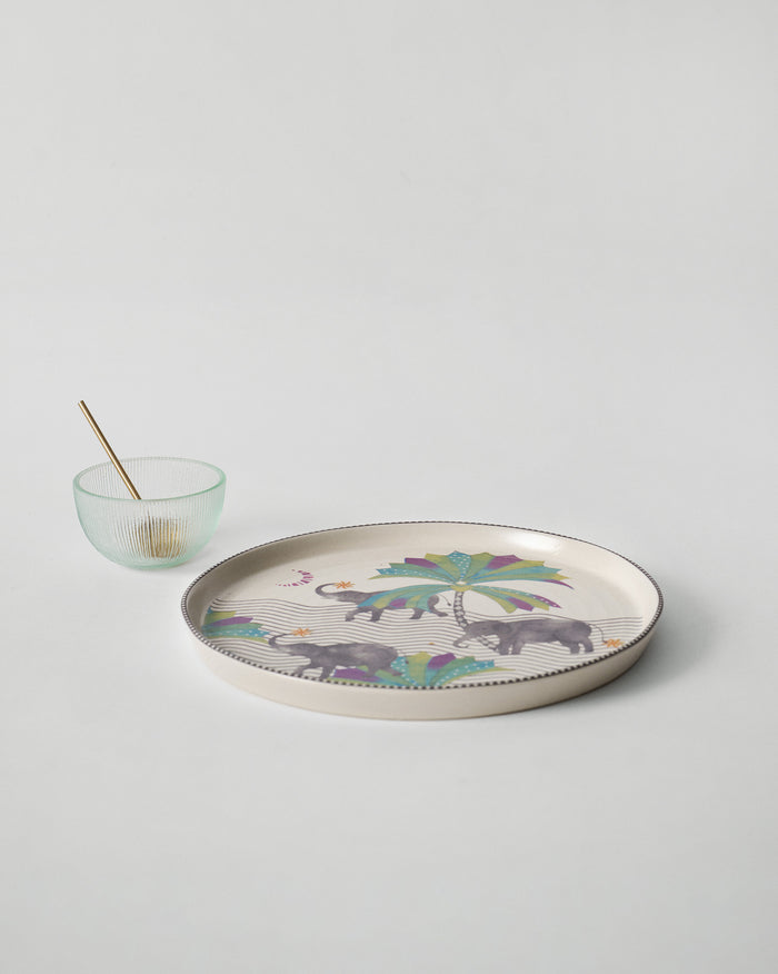 The platter with a small bowl and spoon alongside