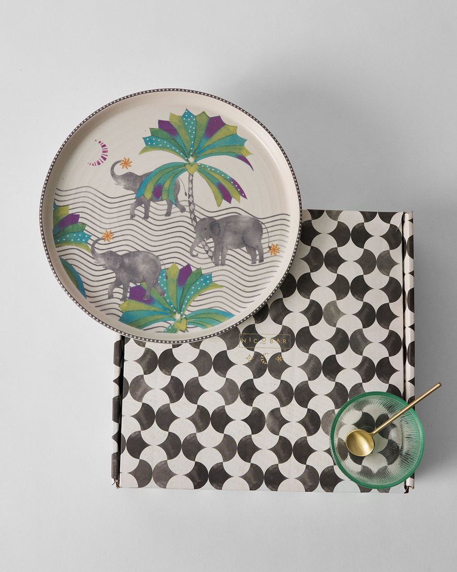 The Tusk platter resting on its black and white patterned gift box