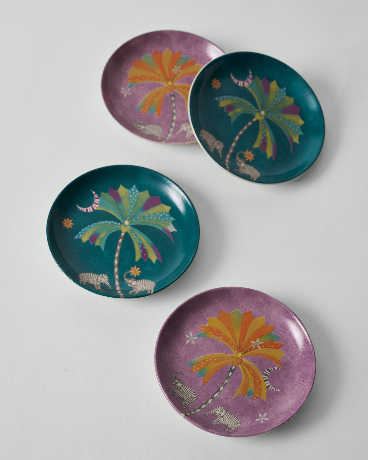 Palm Bloom tea plates alternating teal and purple palm designs.