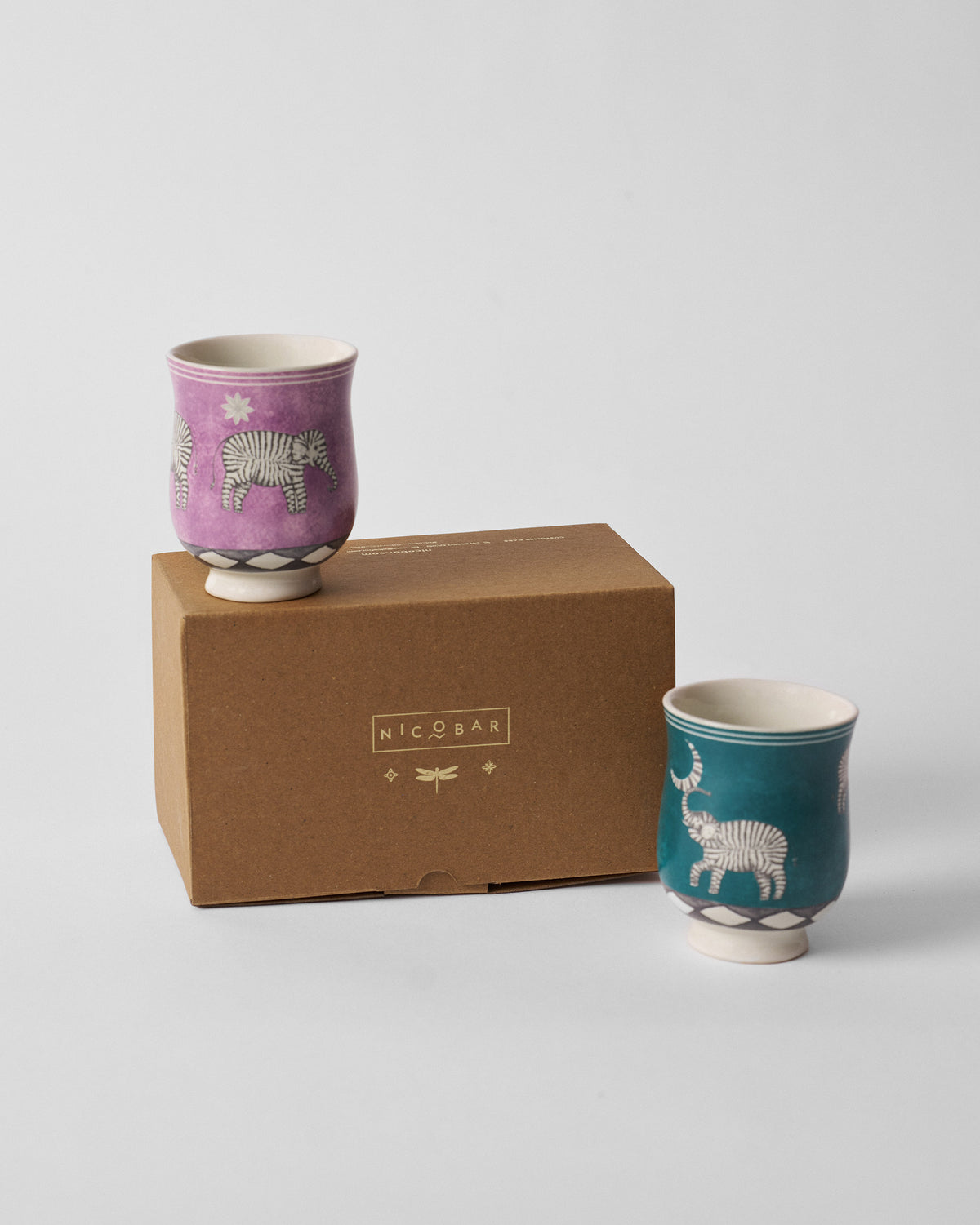 Tusk tea cups beside a kraft Nicobar gift box.