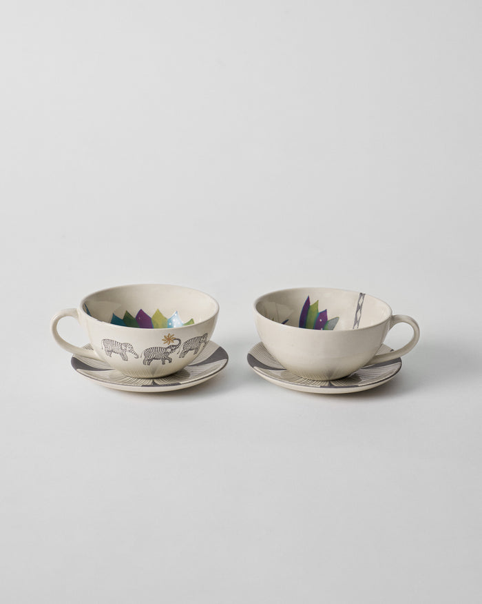 Palm Bloom coffee cups with saucers showing elephant exteriors and colorful interior rims.