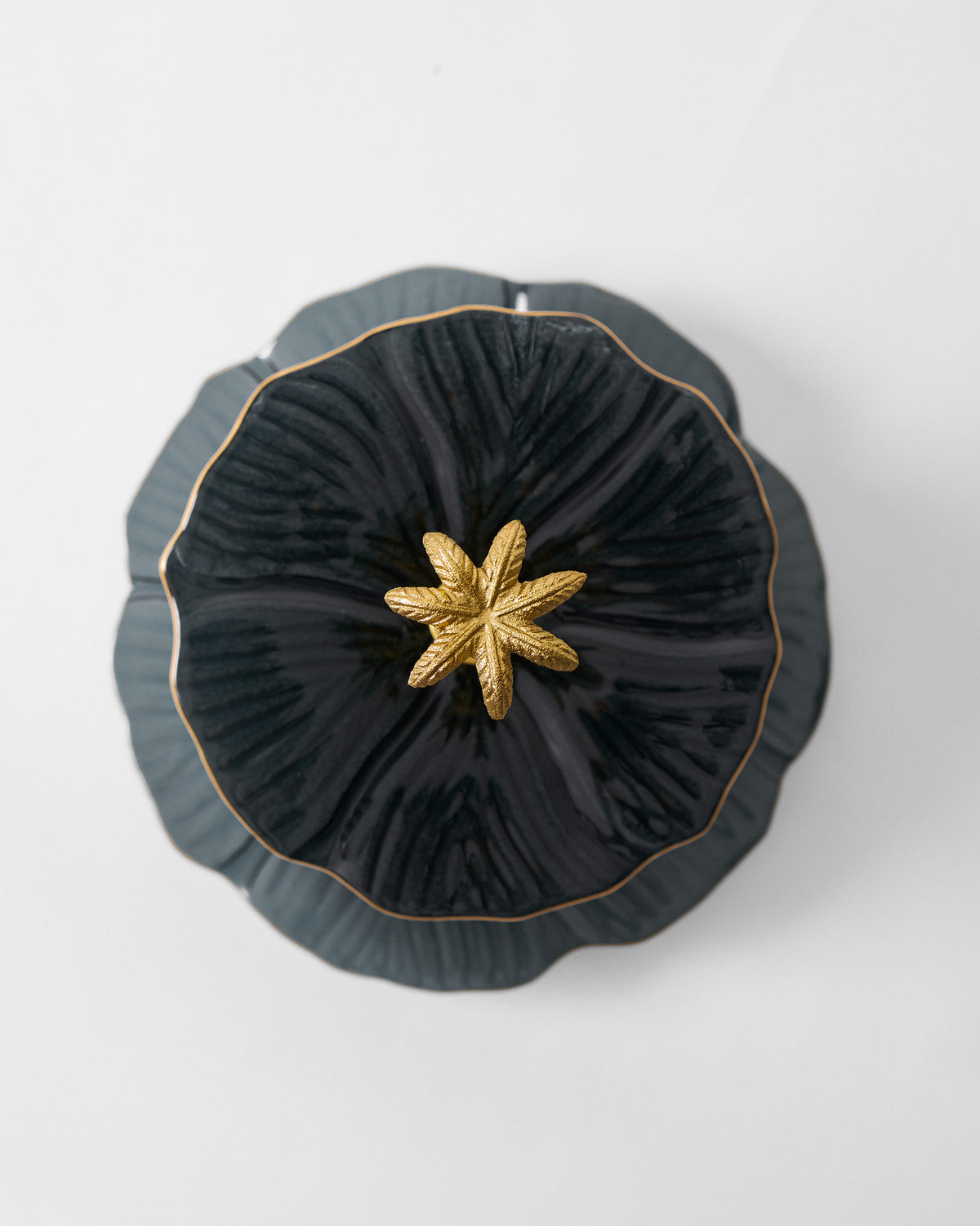 Overhead close-up of a Phool Cake Stand - Charcoal tier with a gold star centre.