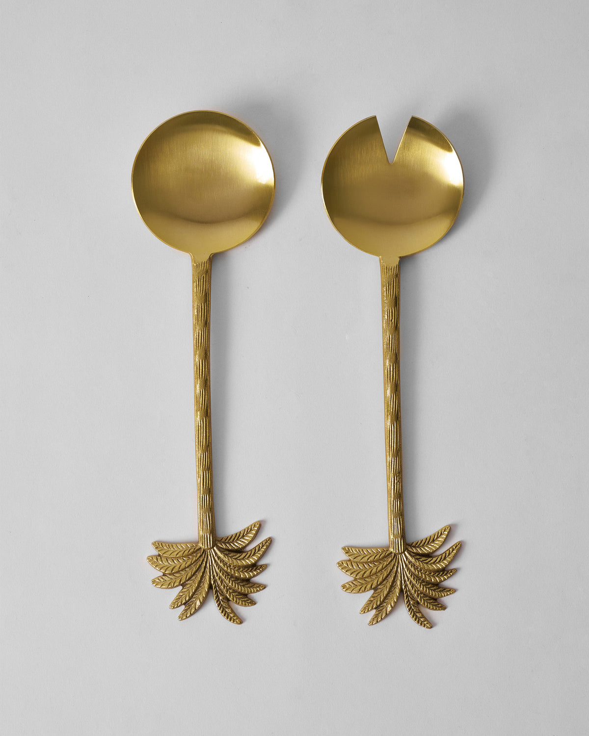 Pair of gold Palm Bloom salad servers with palm frond handle ends.