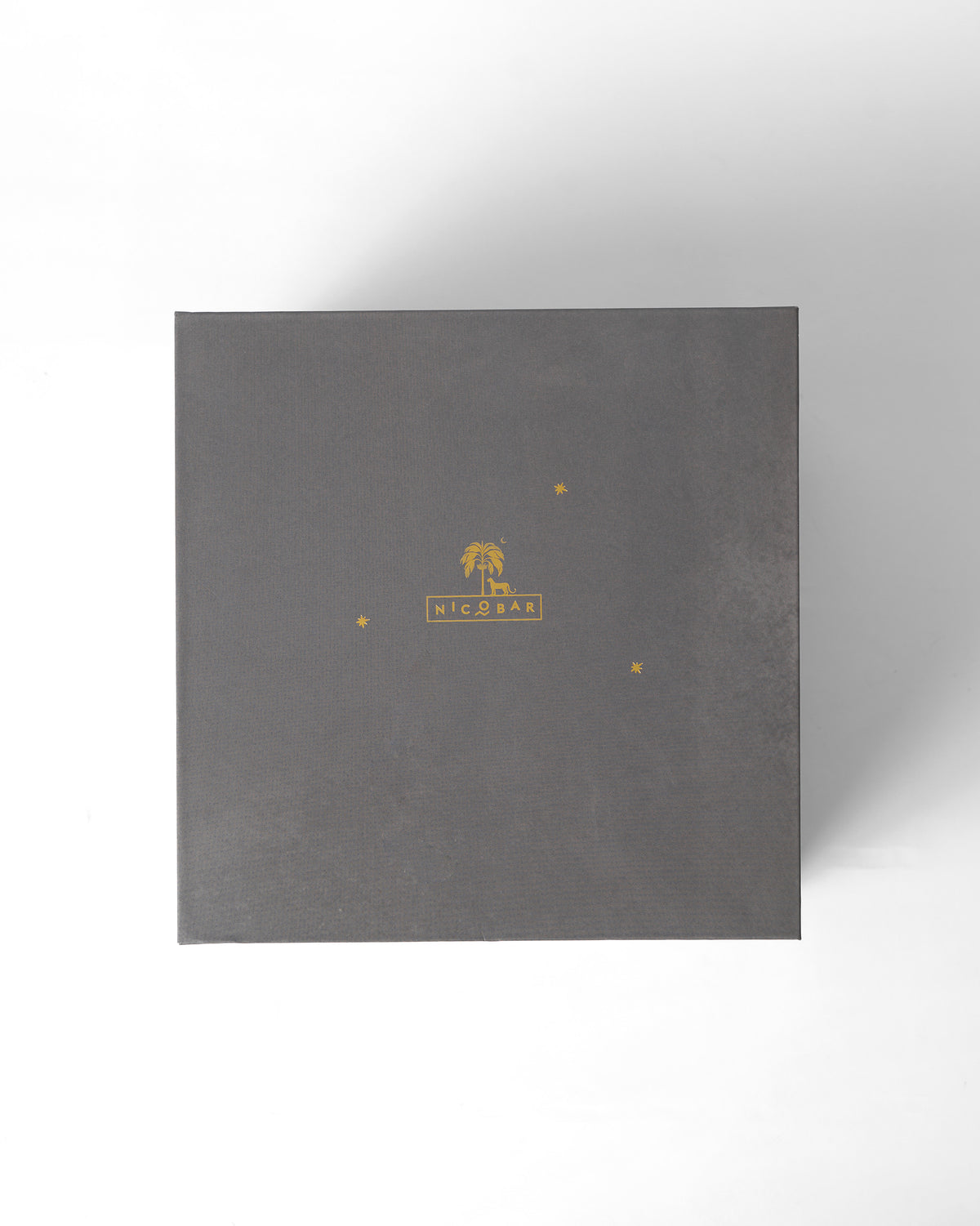 Charcoal Nicobar gift box with a gold palm tree logo for the Matcha set.