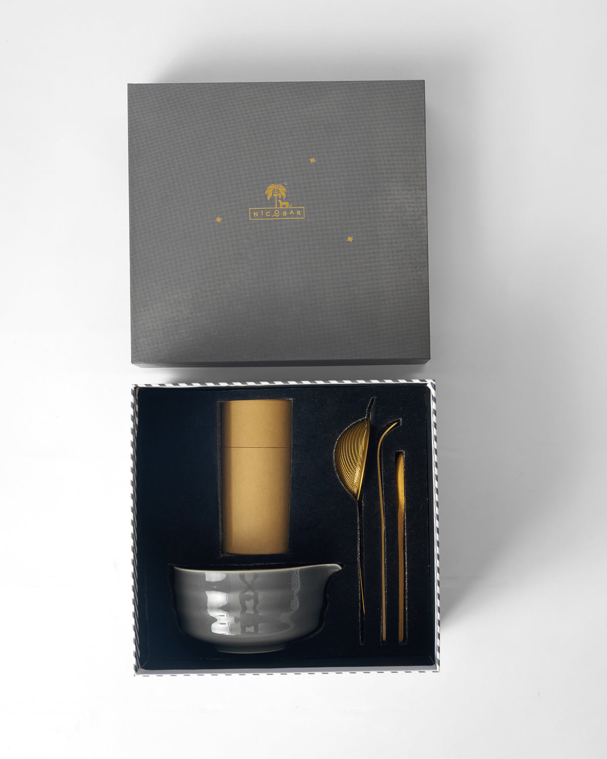 Palm Bloom Matcha tools nestled in an open charcoal Nicobar gift box.