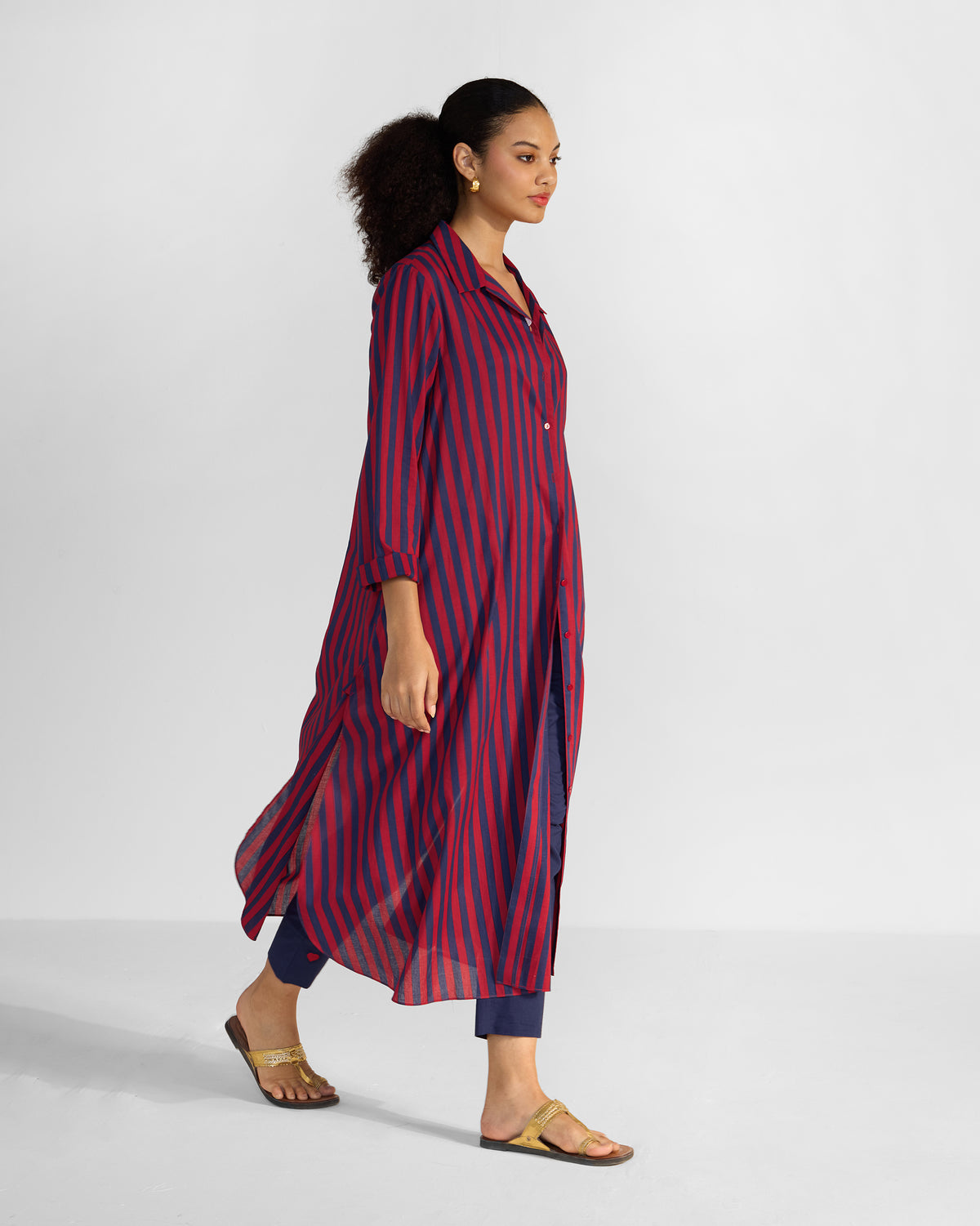 Side view of a red and navy striped Nimar long shirt with side slits.