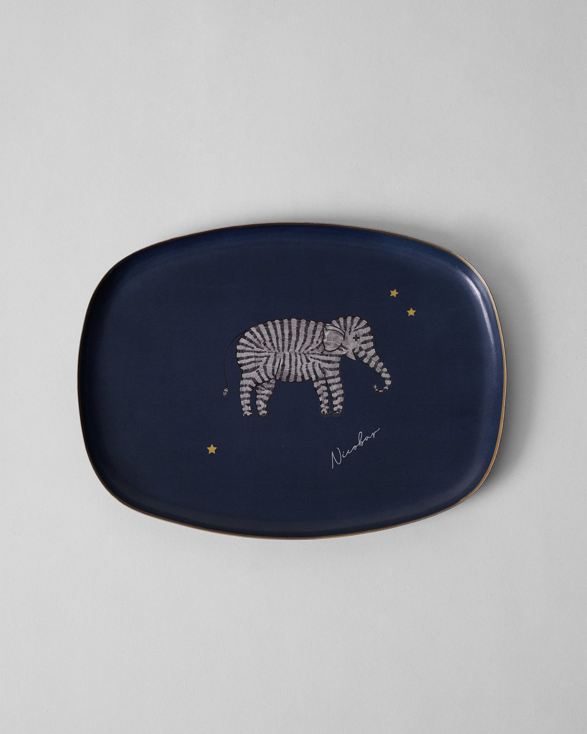 Navy Tusk trinket tray with a striped elephant and small gold stars.