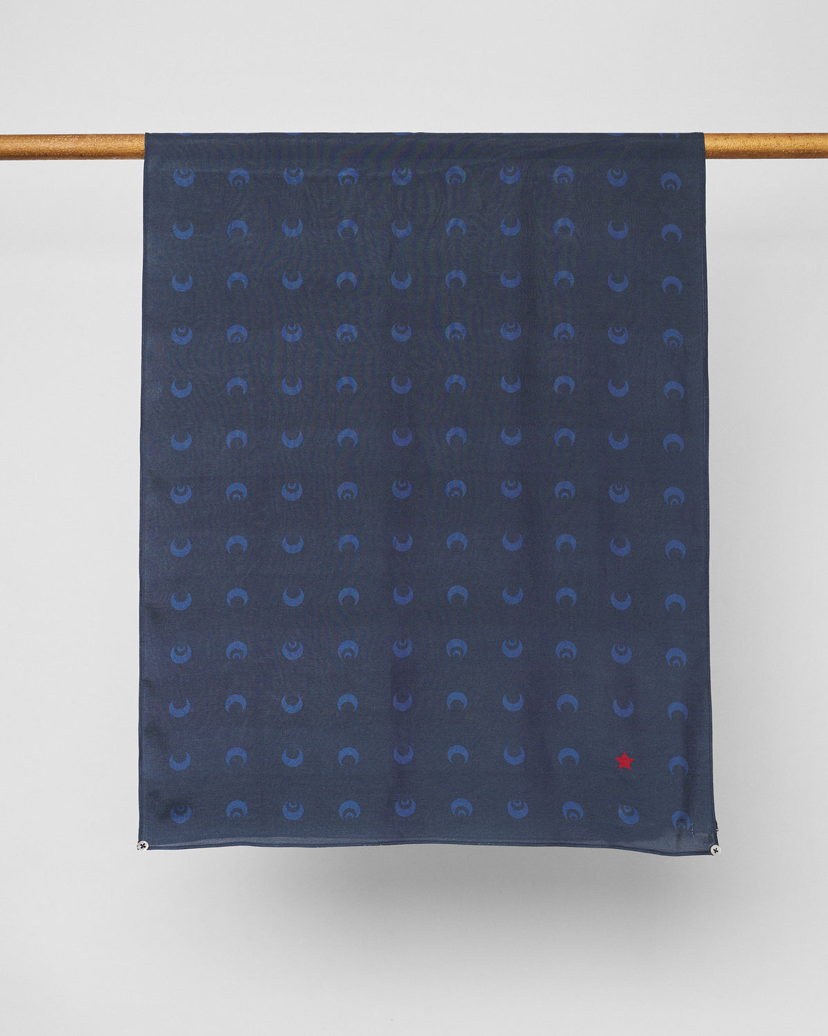 Navy Moonlit scarf hung flat, showing the repeating crescent moon pattern.