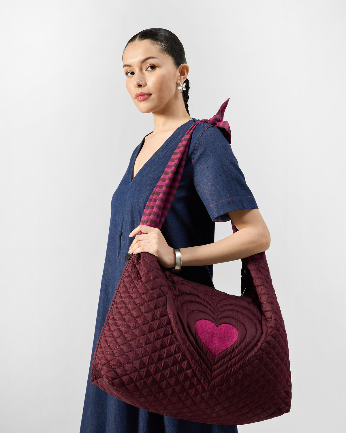 Mulberry Farah Bag with a pink heart worn on the shoulder.