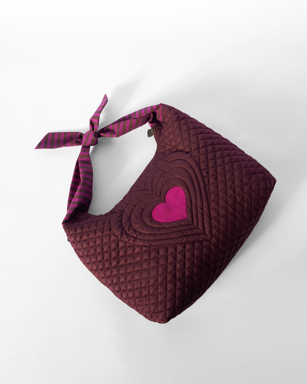 Quilted mulberry Farah Bag with a pink heart motif.