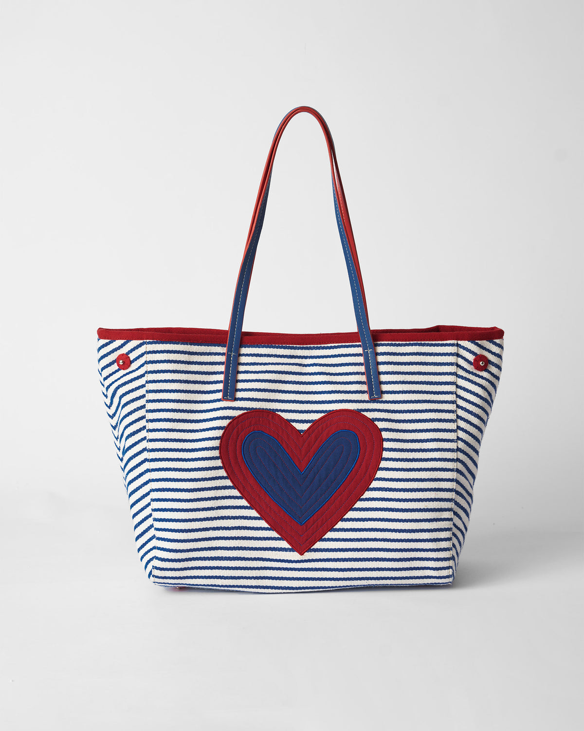 Blue and white striped Kira Bag with a large red and blue heart on the front.