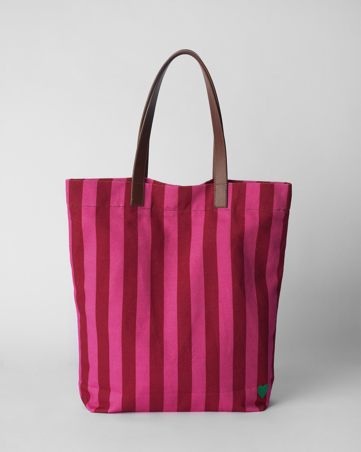 Pink and maroon striped Mukayu city tote with brown leather straps.
