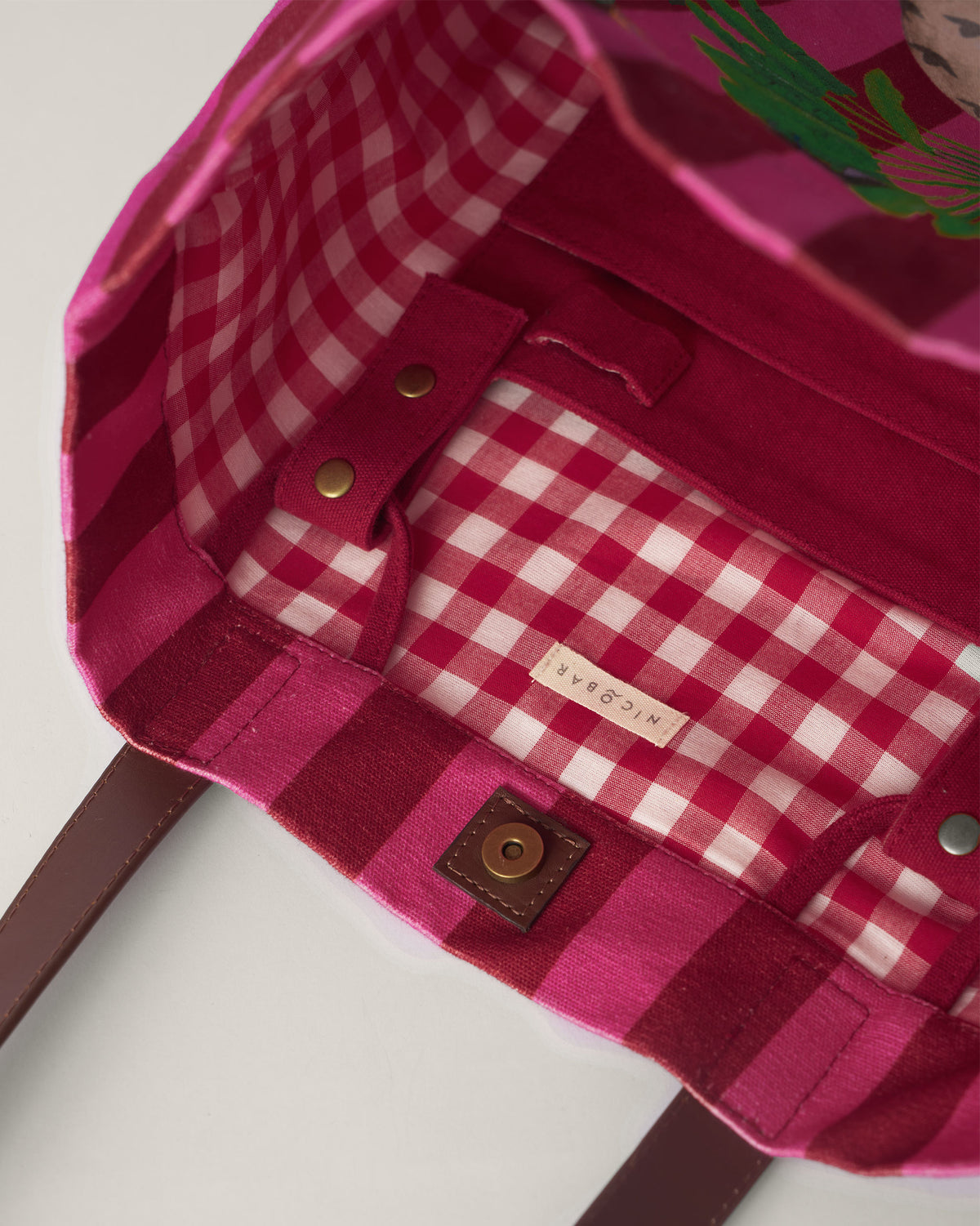 Interior of a Mukayu city tote with a red gingham lining.