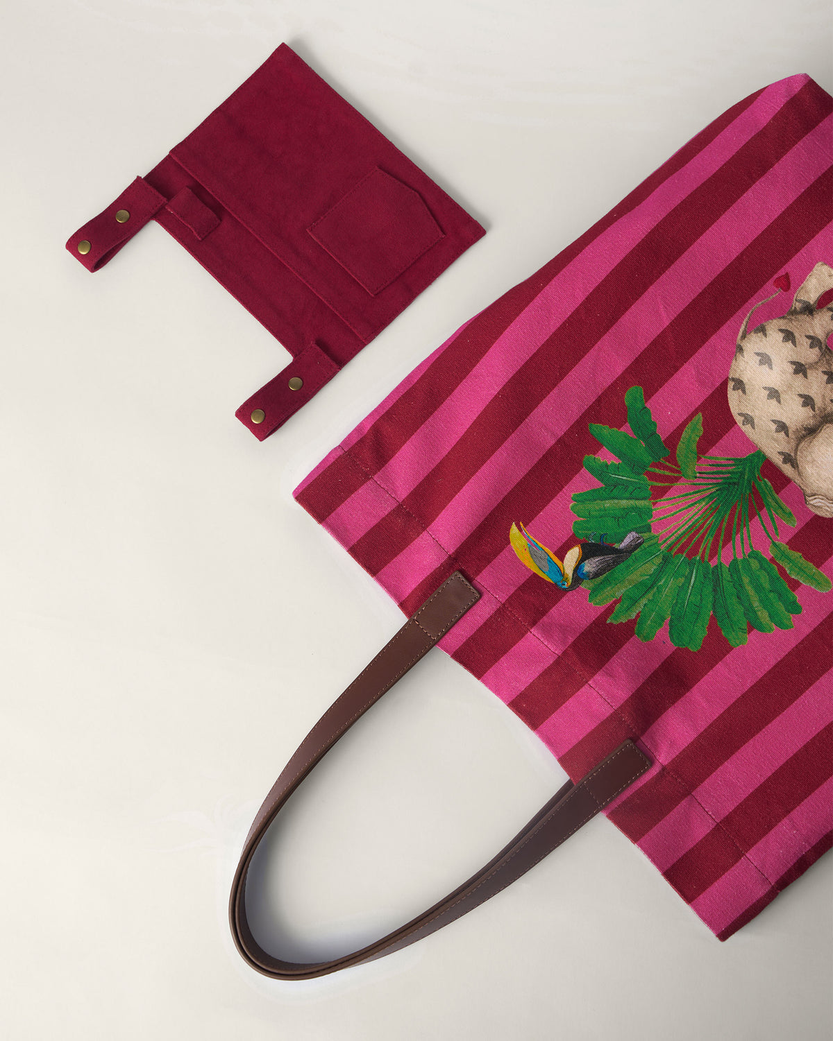 Pink and maroon Mukayu city tote laid flat with a matching pouch.