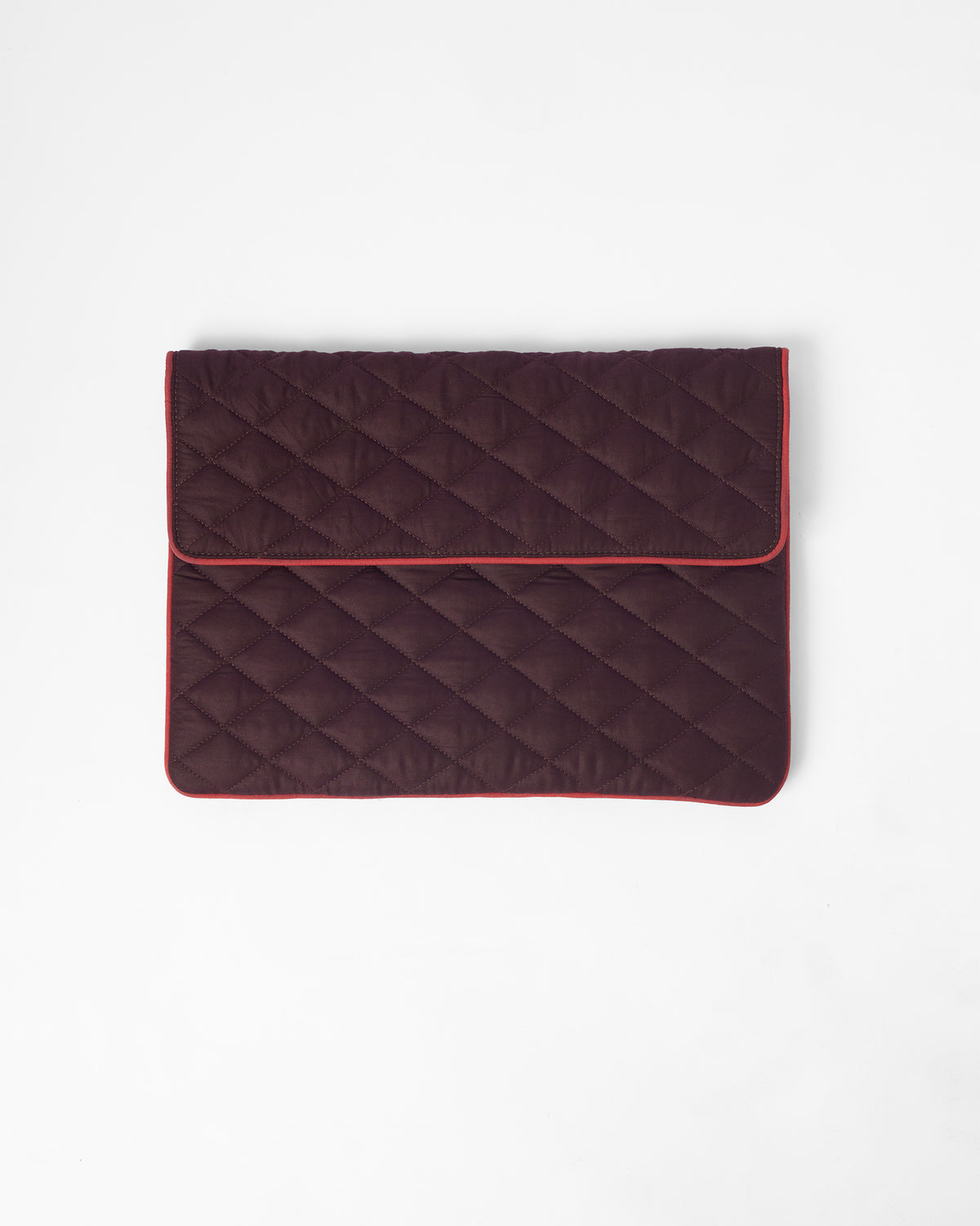 Brown quilted Ele laptop sleeve with red piping.