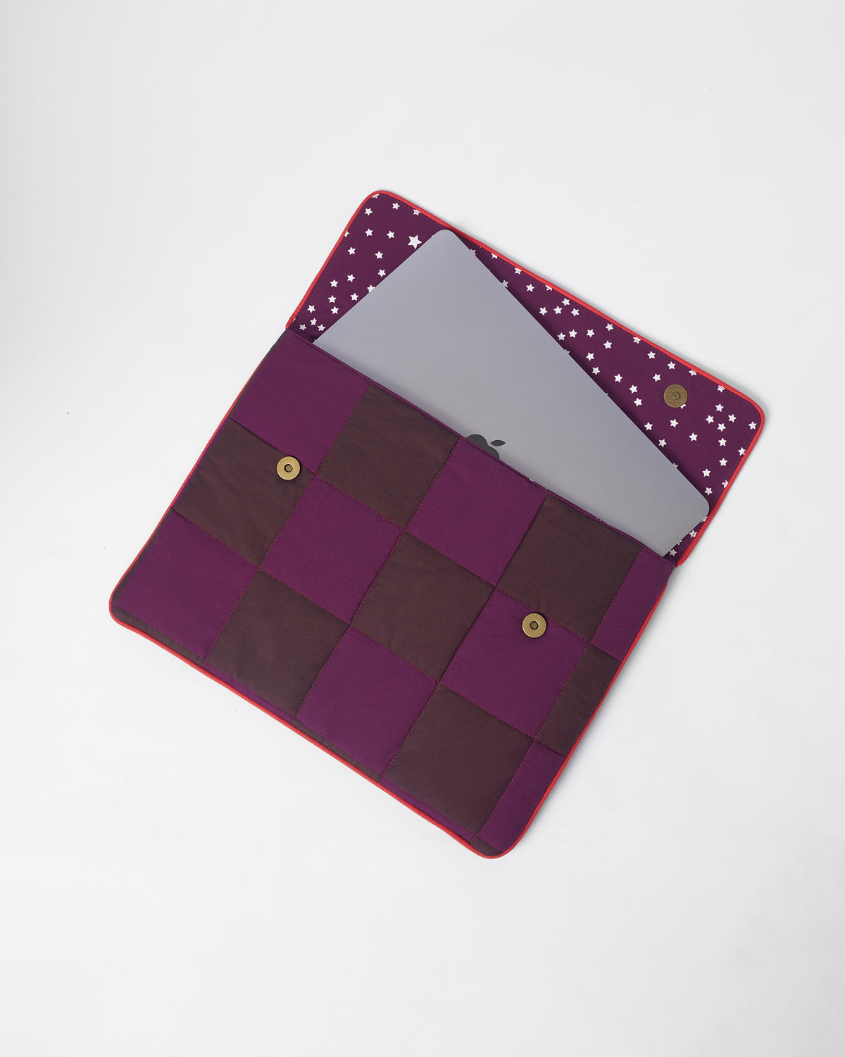 Open Tiled Laptop Sleeve with star lining holding a slim laptop.