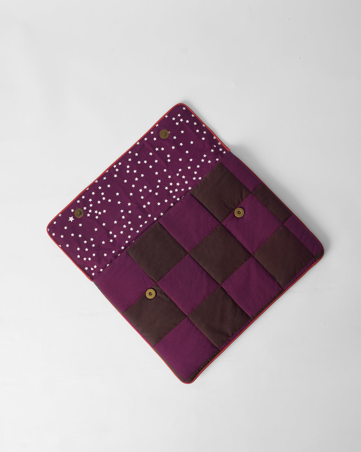 Open brown and mulberry Tiled Laptop Sleeve with star lining and brass snaps.