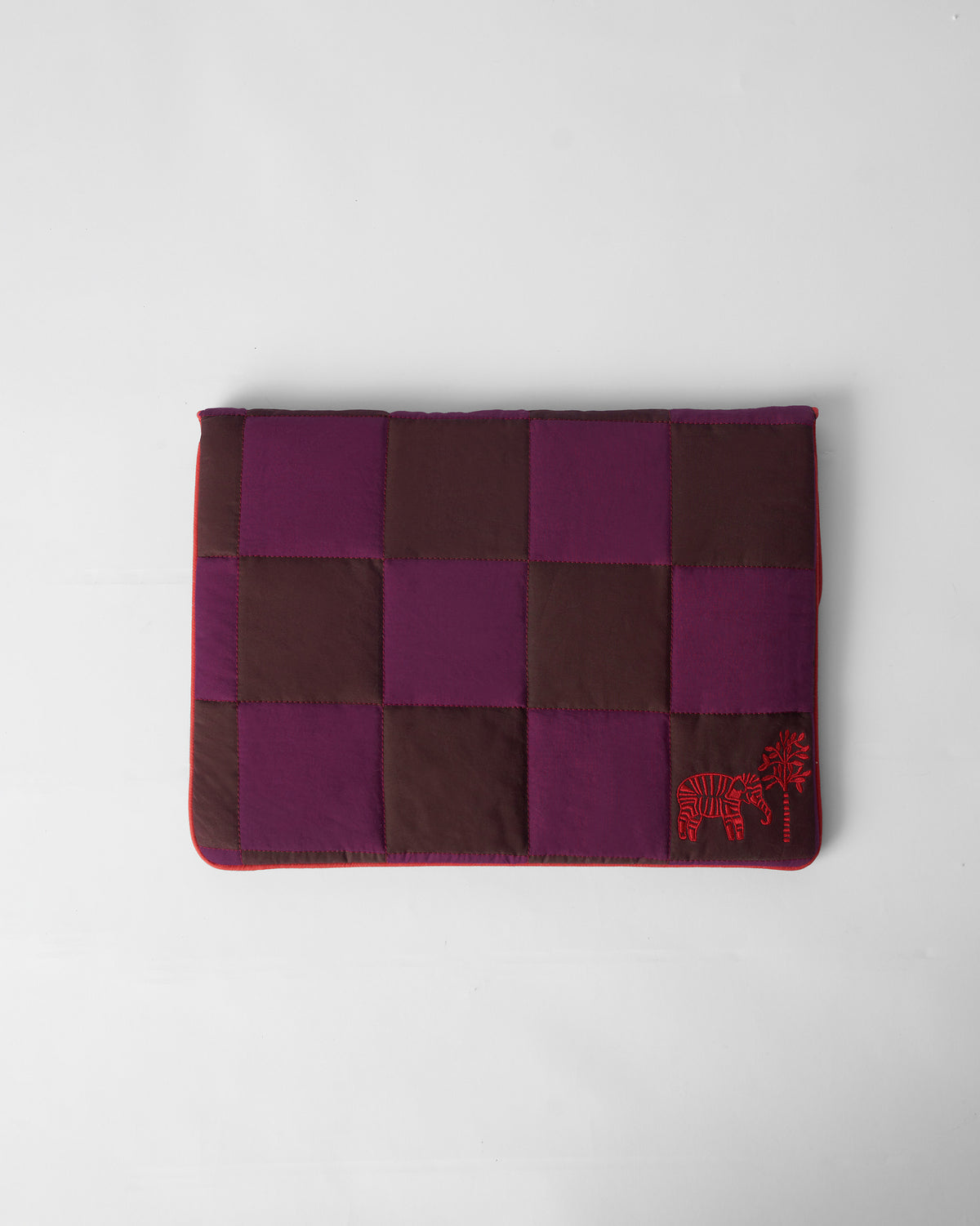 Brown and mulberry Tiled Laptop Sleeve with red elephant embroidery and piping.