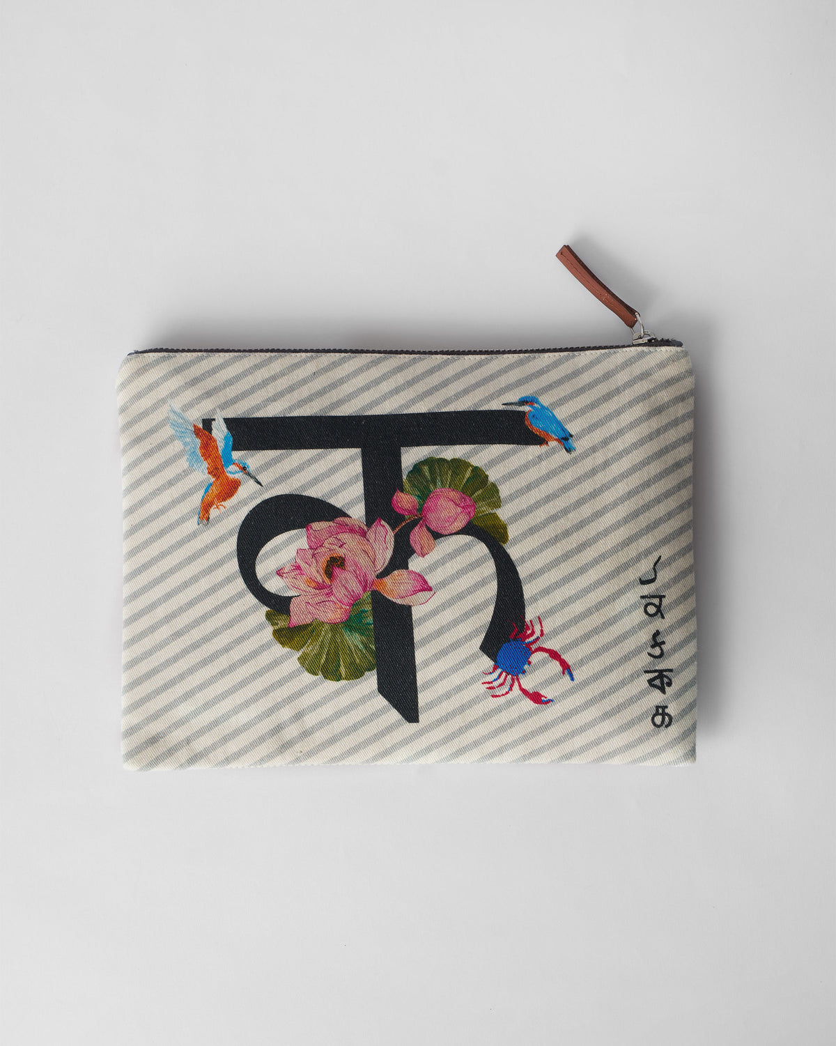 Ivory Kamal Pouch with a black letter print, pink lotus, and kingfishers.
