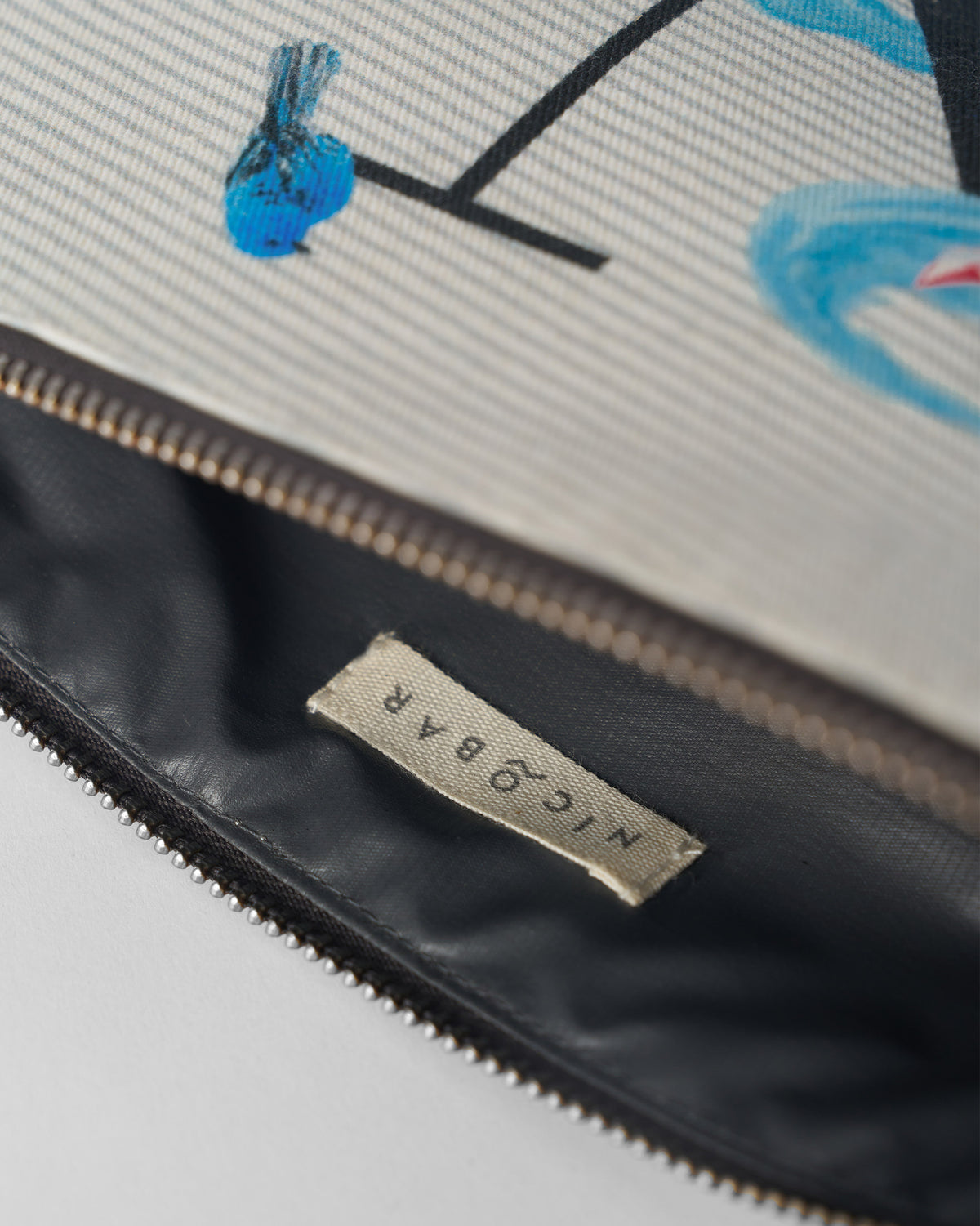 Open ivory Nilambari Pouch showing the dark lining and Nicobar label.