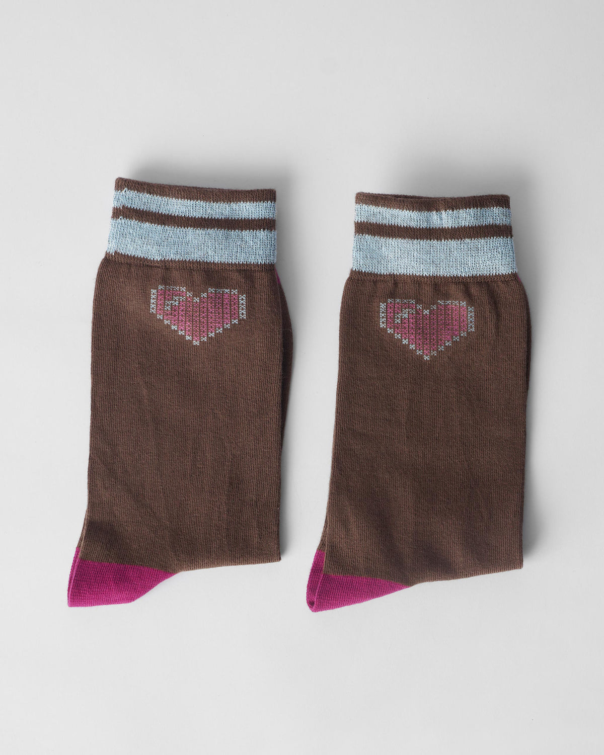 Pair of brown Pixel Heart Socks with blue cuffs and fuchsia toes laid flat.