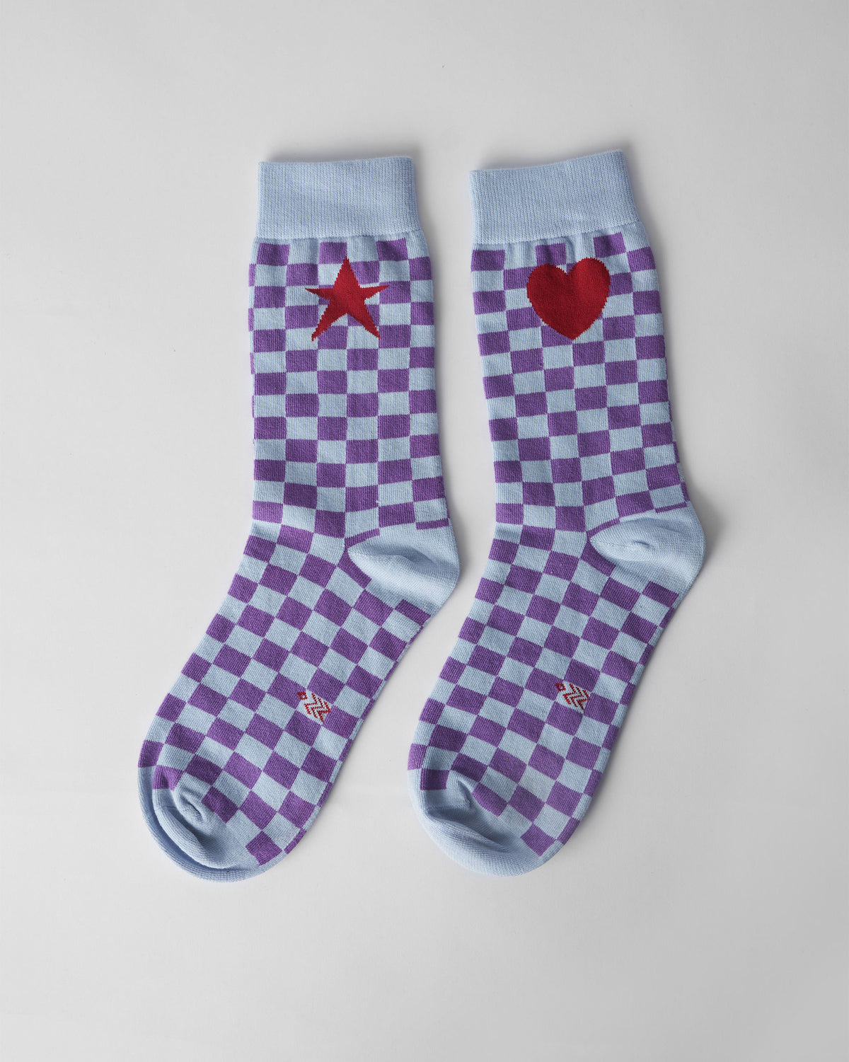 Pair of ice blue and purple Gingham Glow Socks with a heart and star.