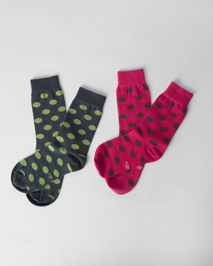 Pair of fuchsia and charcoal Polka Love socks with polka dots.