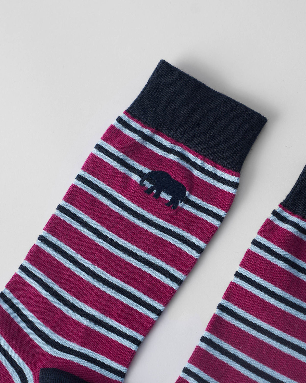 Close-up of mulberry Stripey Socks with light blue stripes, navy cuff, and small elephant embroidery.
