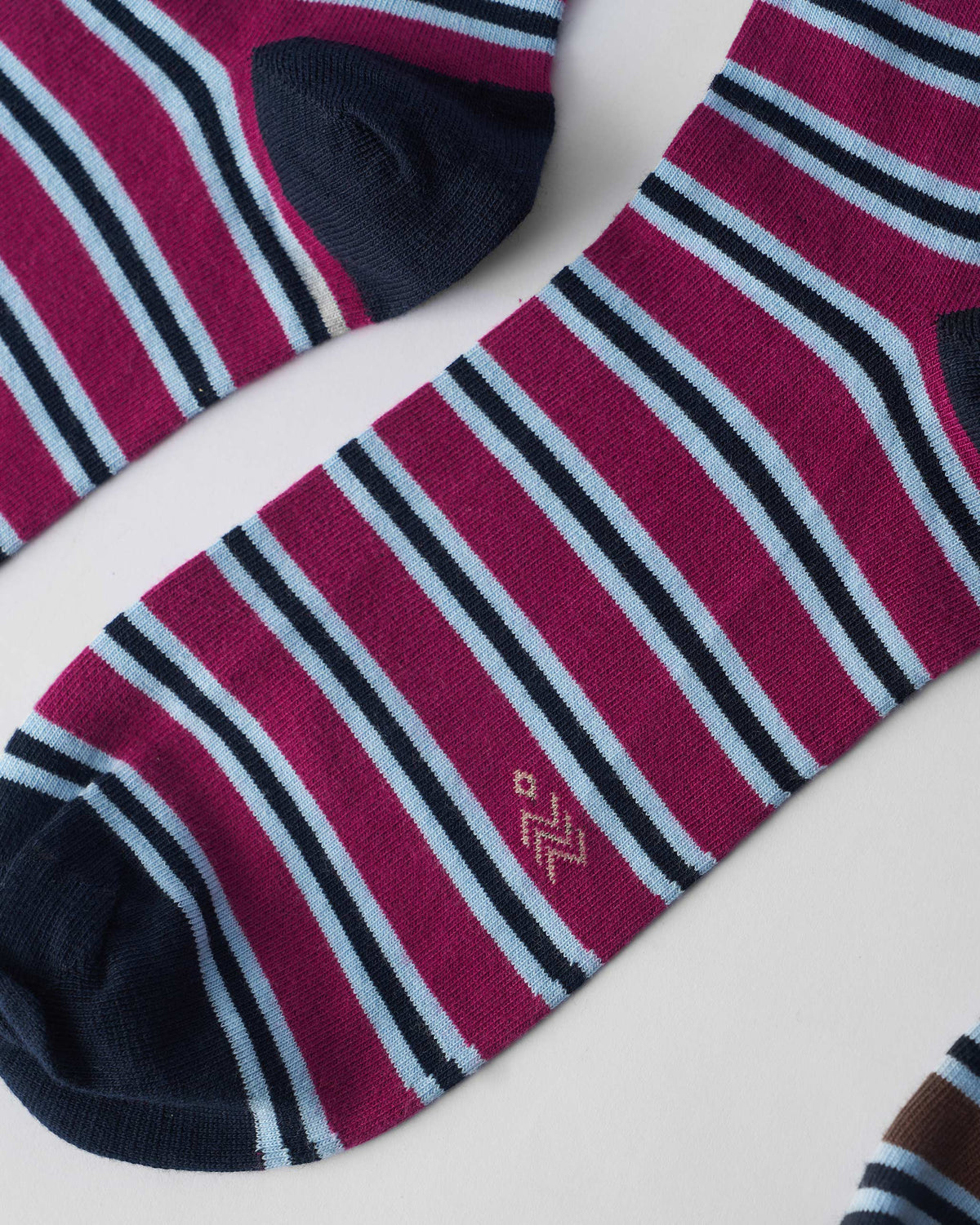 Close-up of mulberry Stripey Socks showing navy toe and fine horizontal stripes.