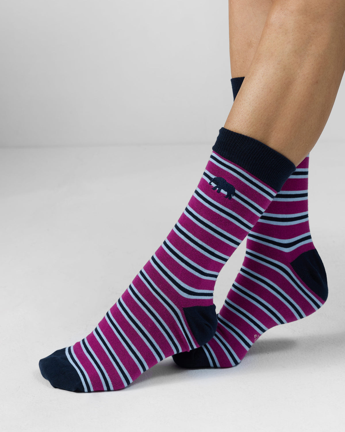 Mulberry Stripey Socks worn on crossed feet with navy cuff and elephant motif.