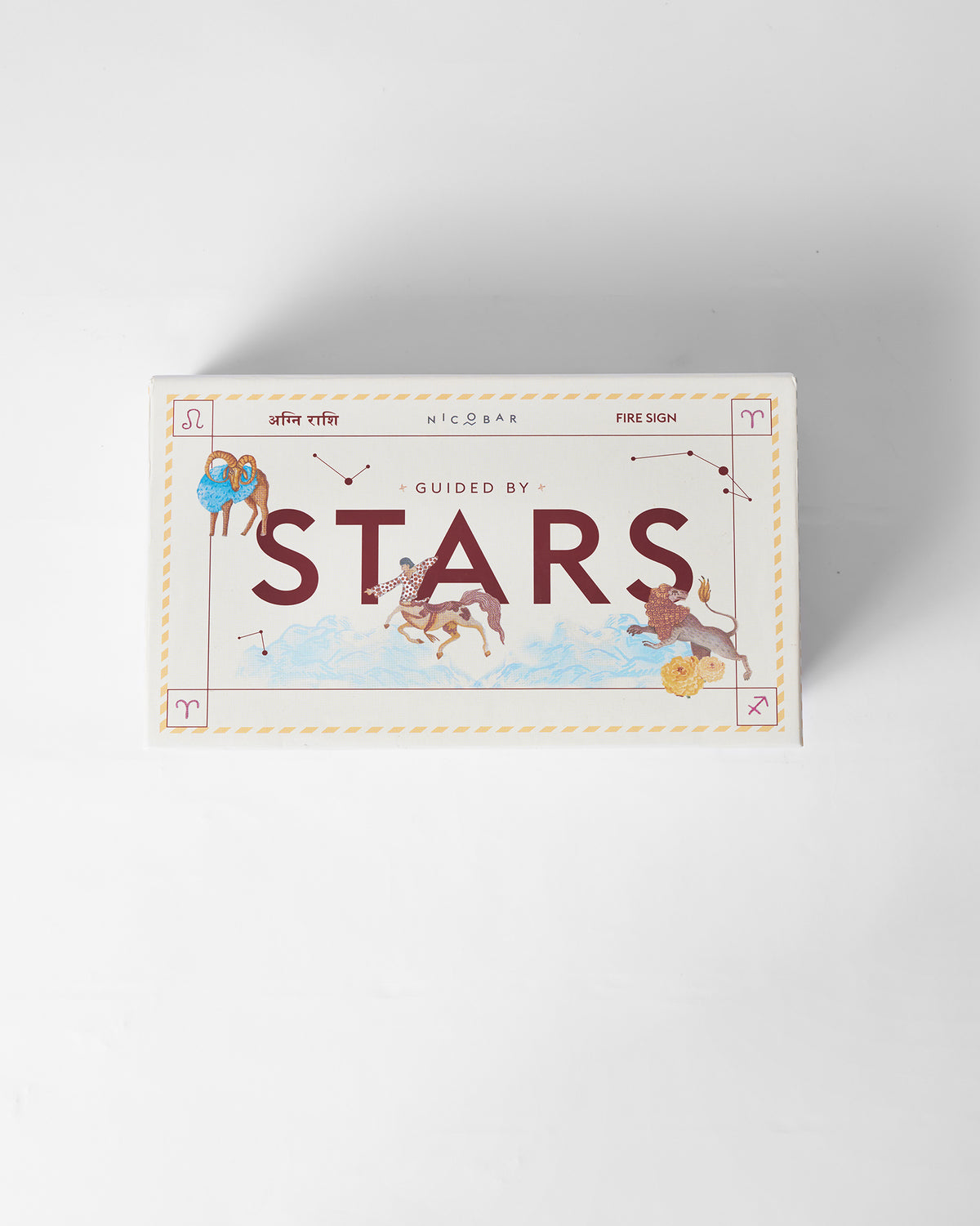Closed Nico Sagittarius gift box with Guided by Stars fire-sign art.