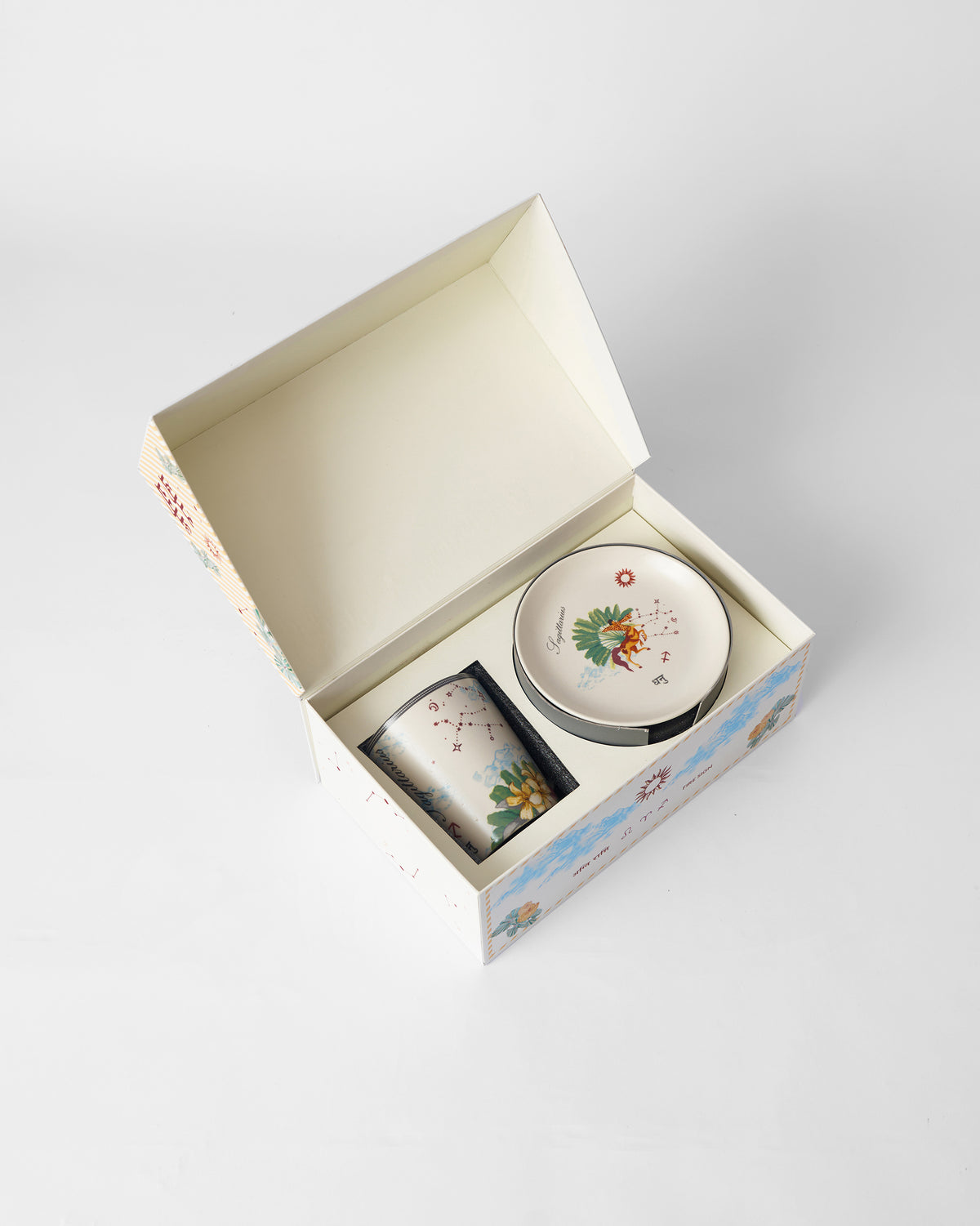 Open Nico Sagittarius gift box with mug and tea plate inside.