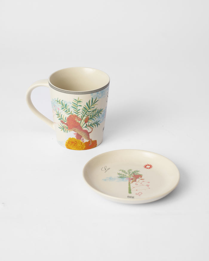 Nico Leo mug with a lion print beside a matching tea plate.