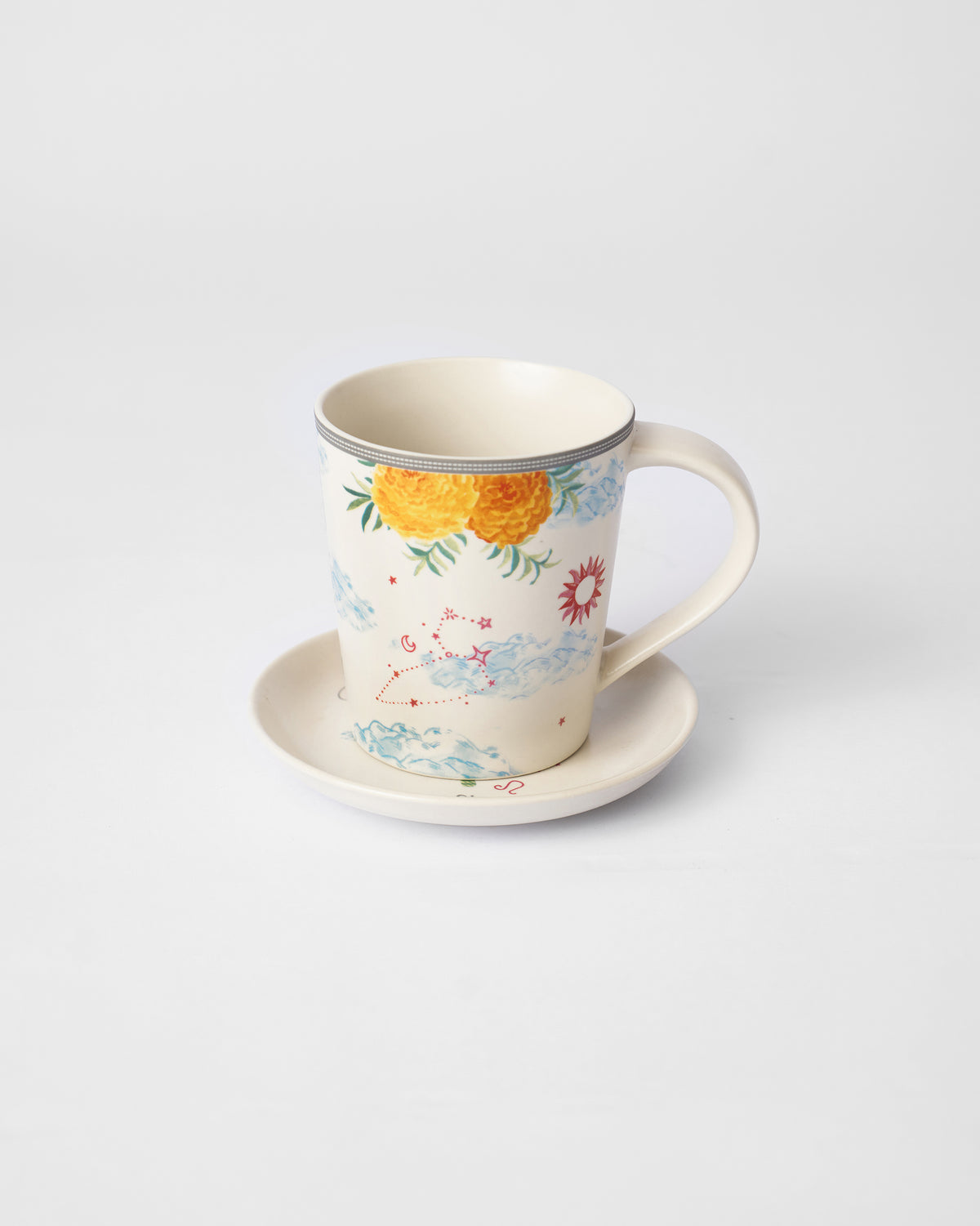 Nico Leo mug with marigolds and a red sun on its tea plate.