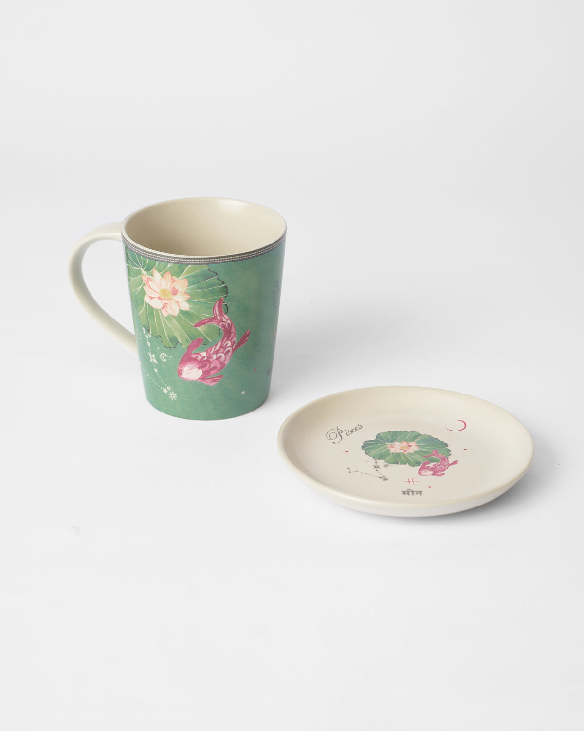 Nico Pisces Gift Set mug beside its saucer, with a lotus and pink fish design.