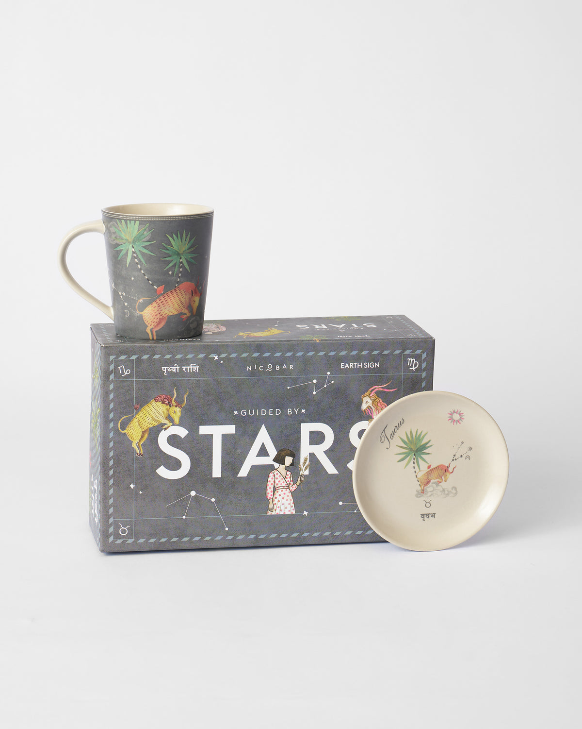 Nico Taurus mug and tea plate in front of the Guided by Stars gift box.