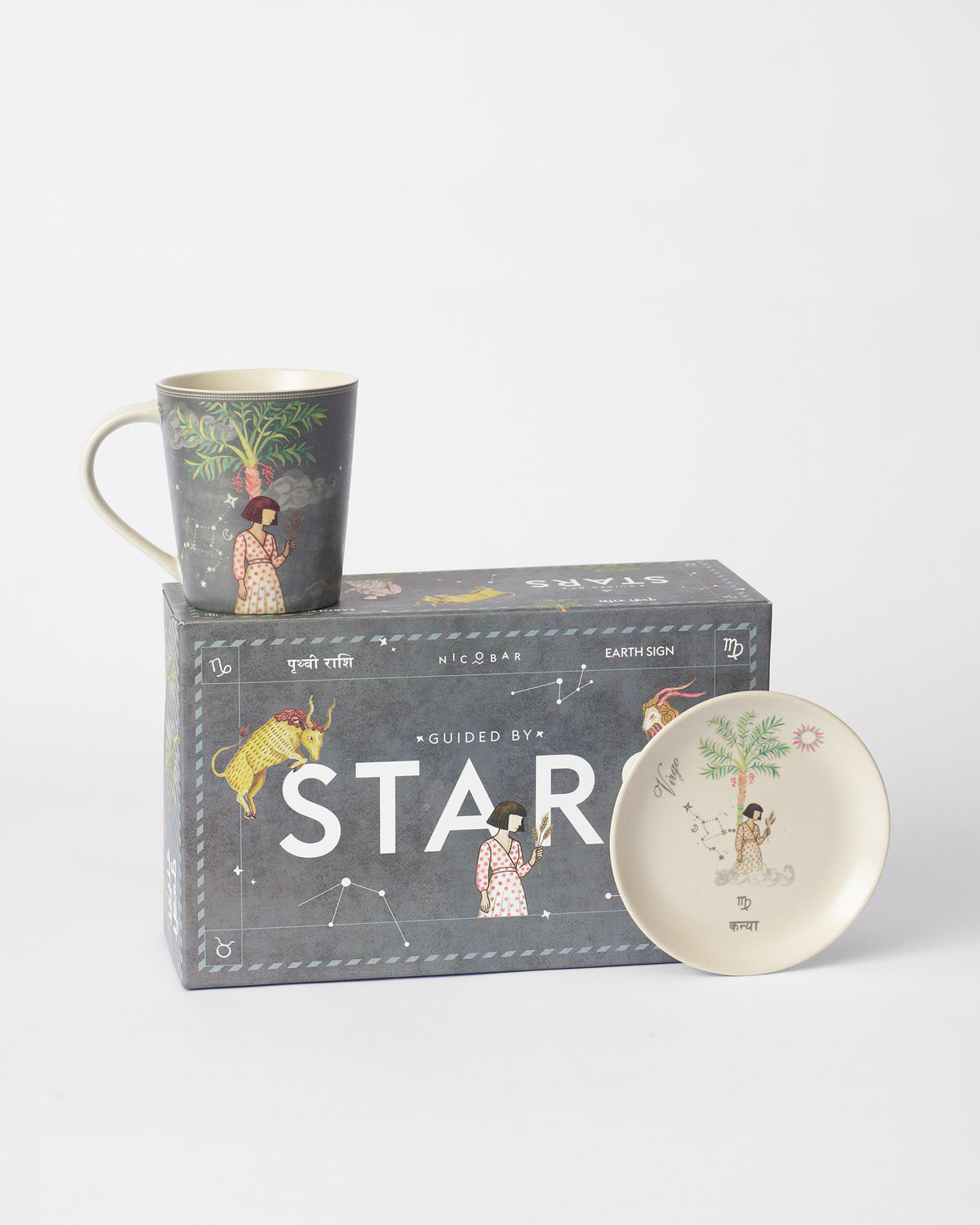 Nico Virgo mug and tea plate in front of the Guided by Stars gift box.