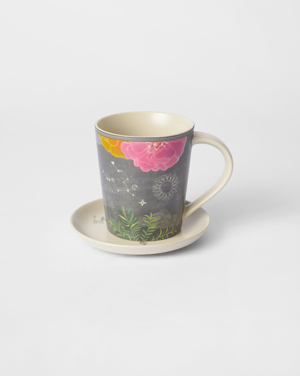 Nico Virgo mug with pink flowers and constellation dots on its tea plate.