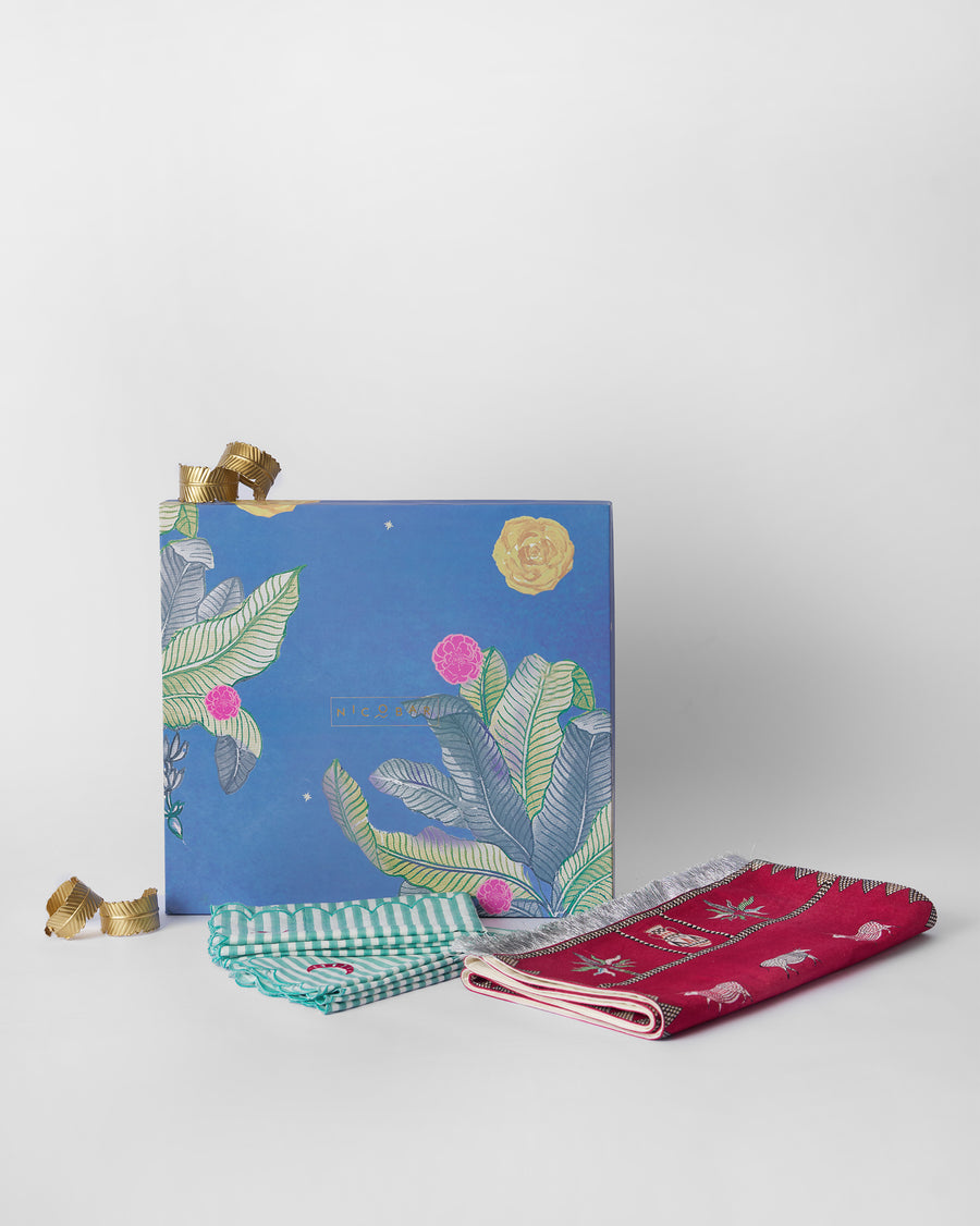 The runner, napkins and rings beside the blue botanical box