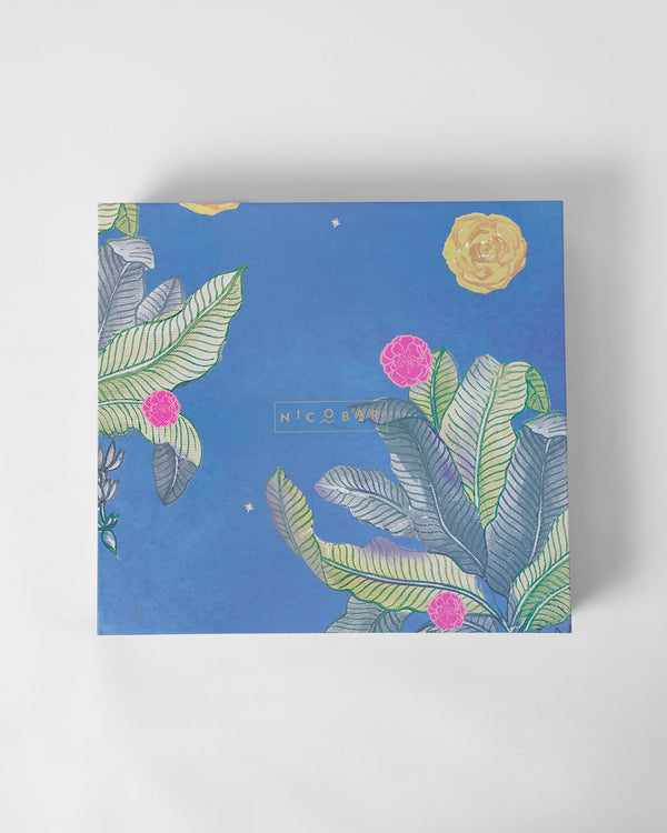 The closed blue box with leaves and pink flowers
