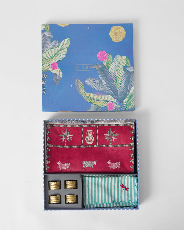 The open box with runner, napkins and gold rings