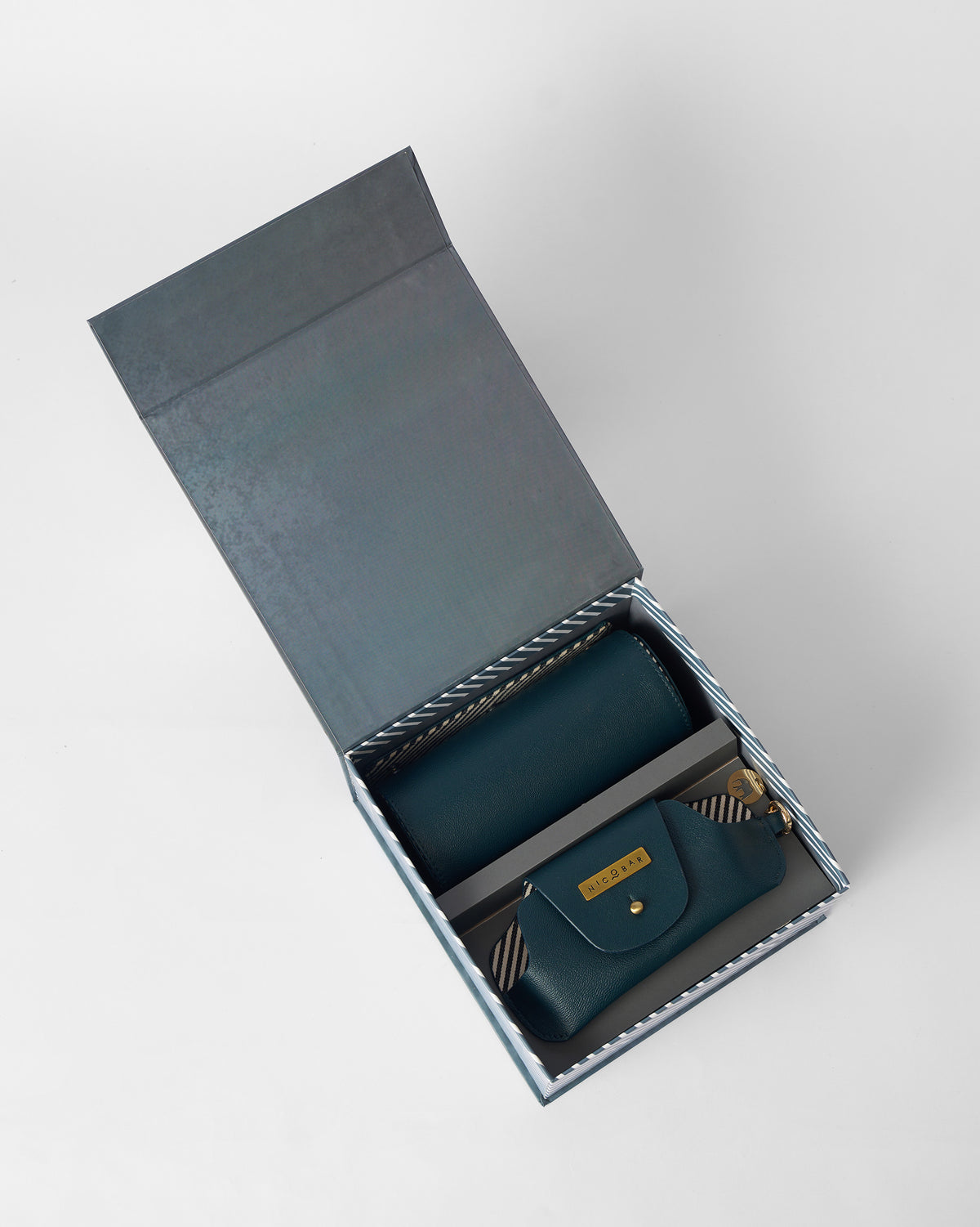 Tusker Gift Set roll case inside an open grey box, seen from above.