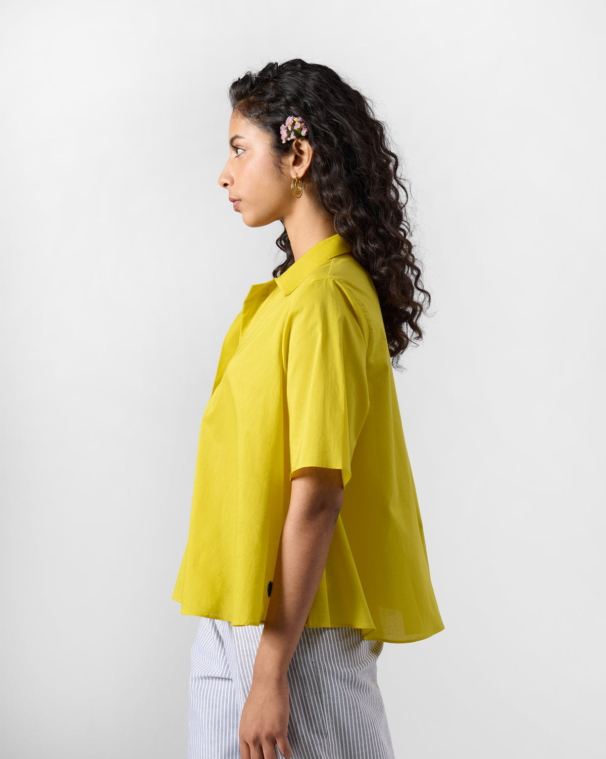 Side view of a chartreuse Rann shirt with short sleeves.