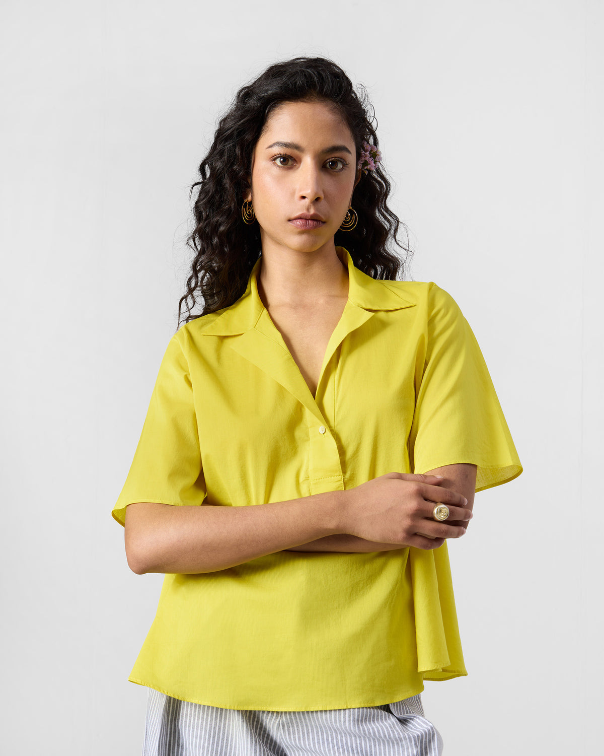 Person wearing a bright chartreuse Rann shirt.